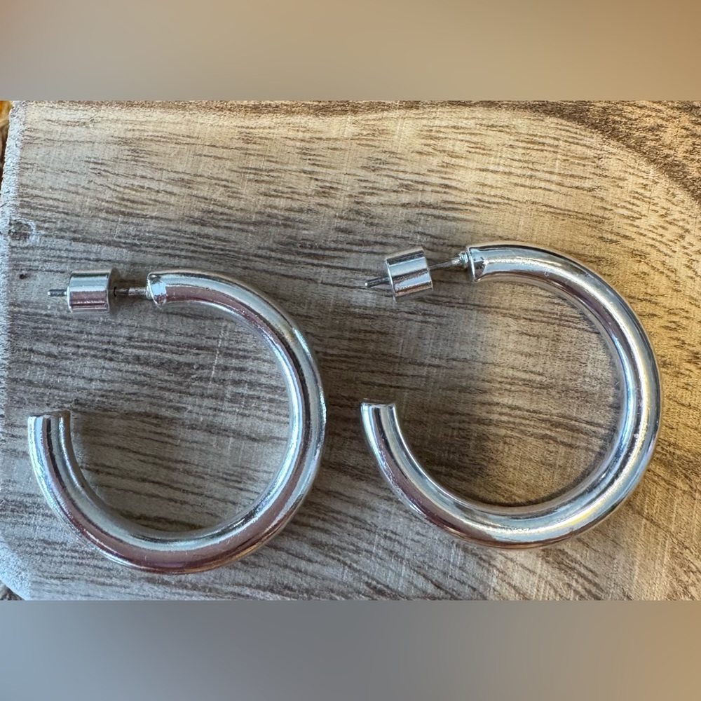Pair of silver colored post back hoop earrings. NWOT purchased from a boutique.